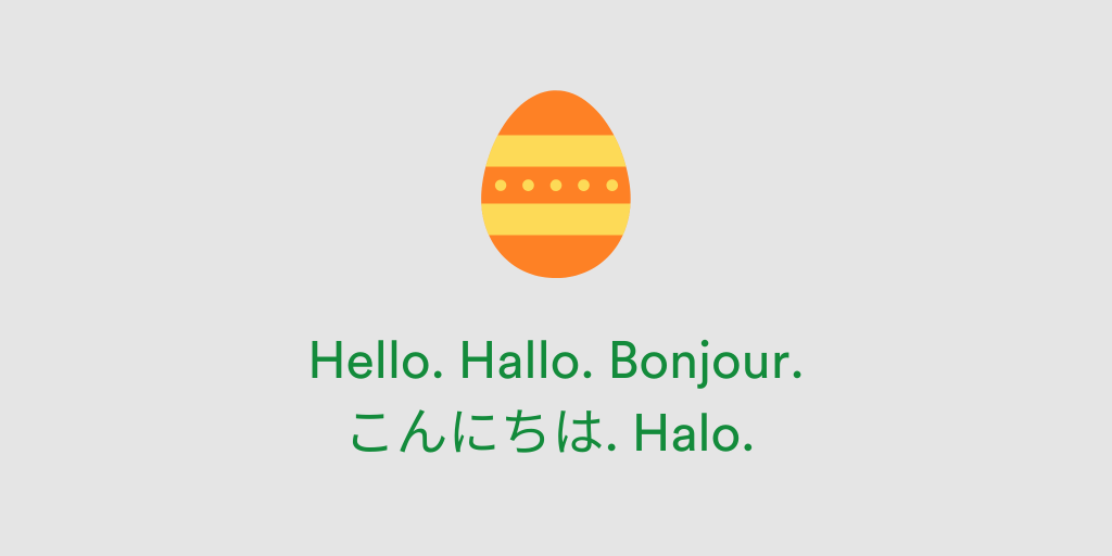 An orange and yellow Easter egg. language options: Hello written in Dutch, Japanese, French, German and Spanish