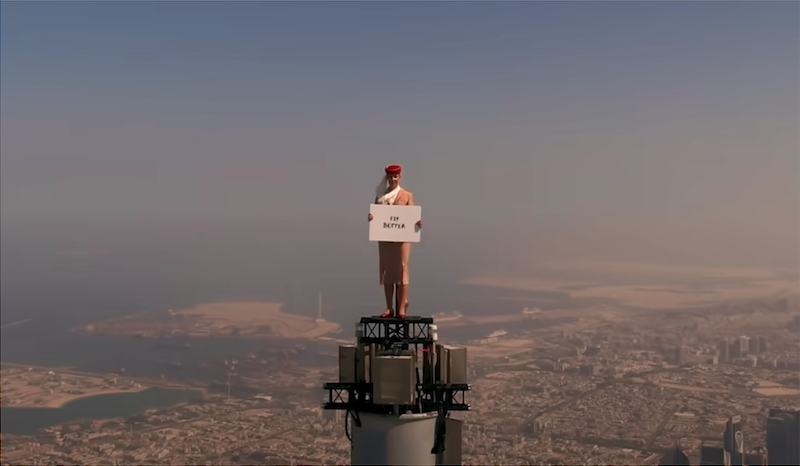 Emirates flight attendant standing on top of the building, 828-metre-high Burj Khalifa