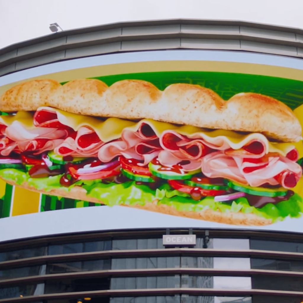 Passersby can see their virtual sandwich creations come to life on the 3D billboard. 